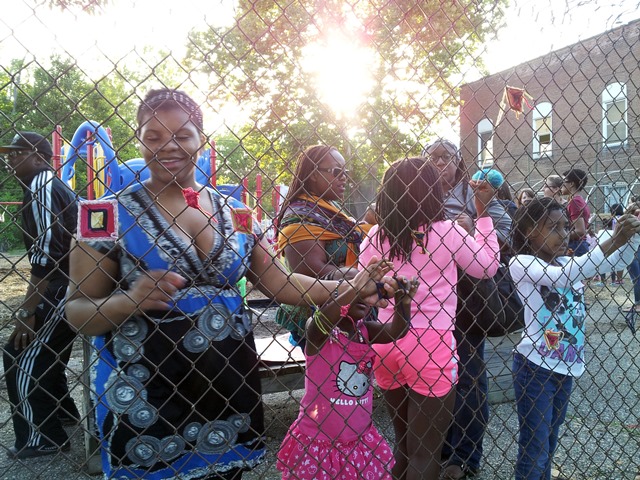 Weaving Protective Eyes, Ojo de Dios, into the Boggs School fence